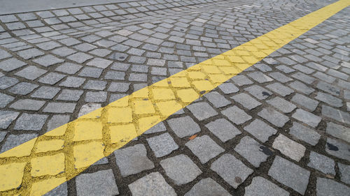 Yellow line splitting a paved road in two sides