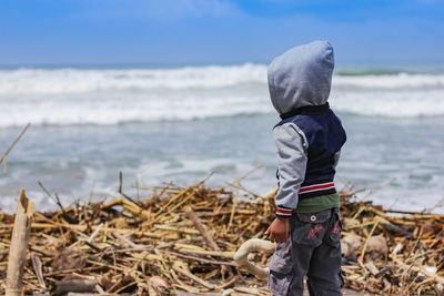 Full length of boy standing on beach