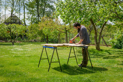 Full length of carpenter working outdoors