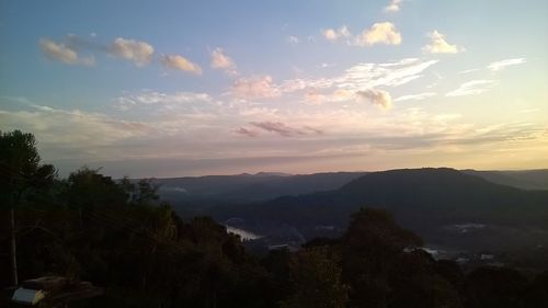 Scenic view of mountains against sky at sunset