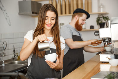 Young couple holding coffee at home