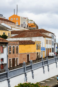 Residential buildings against sky in town