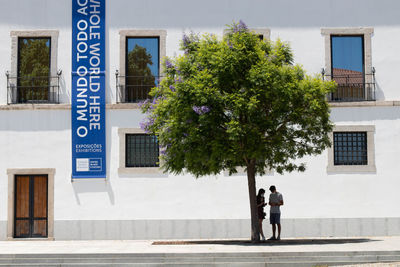 People on road by building