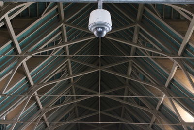 Low angle view of illuminated lighting equipment hanging from ceiling