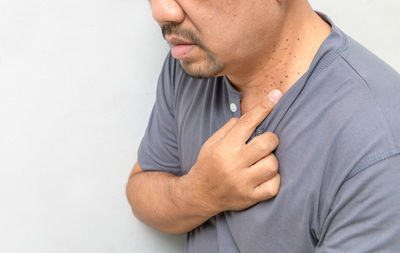 Midsection of man against white background