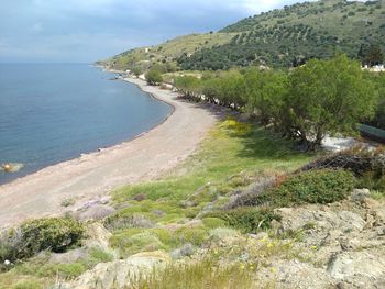 Scenic view of sea and mountains against sky