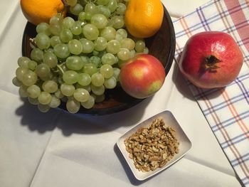 Close-up of fruits with nuts served on table