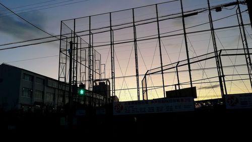 Low angle view of buildings against sky at sunset