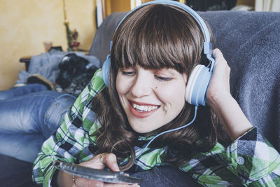 Portrait of smiling girl using mobile phone outdoors