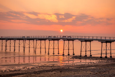 Scenic view of sea against orange sky
