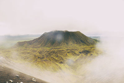 Scenic view of volcanic mountain against sky