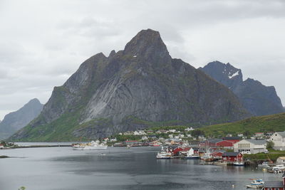 Scenic view of sea and mountains against sky