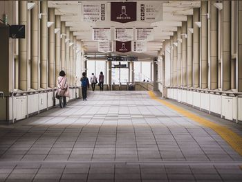 People walking in corridor of building