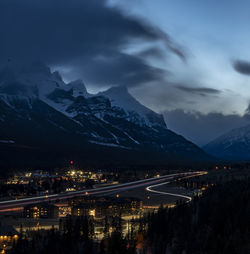 Illuminated city against sky at dusk