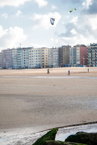 View of beach against buildings in city