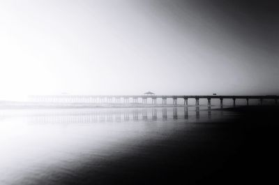 Pier over sea against clear sky