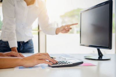 Midsection of business colleagues working in office