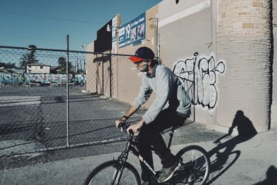 Man riding bicycle on street in city