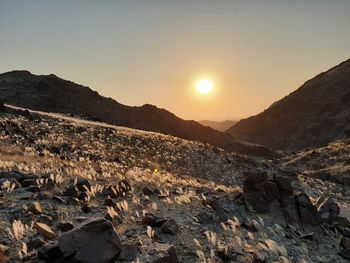 Scenic view of rocky mountains against sky during sunset