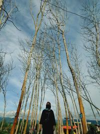 Woman looking away while standing outdoors