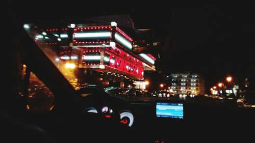 Illuminated city against sky at night