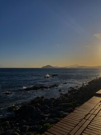 Scenic view of sea against clear sky during sunset