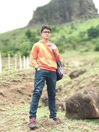 Portrait of young man standing on field