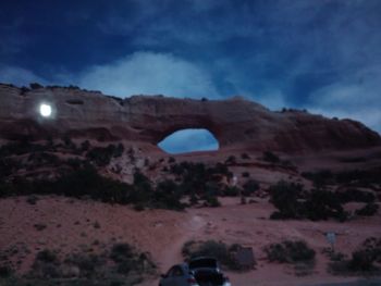 Car on landscape against sky at night