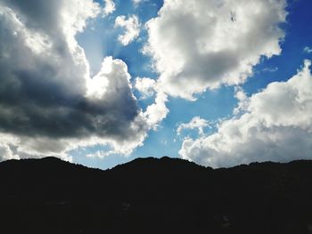 Low angle view of silhouette mountains against sky