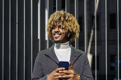 Portrait of young man using mobile phone