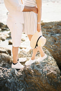 Low section of people walking on rock