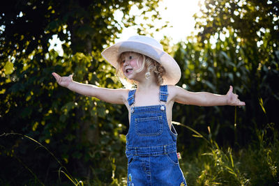 Portrait of little girl playing with hat