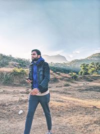 Full length of man walking on landscape against sky