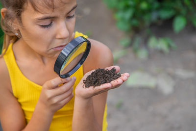 Midsection of woman holding sapling