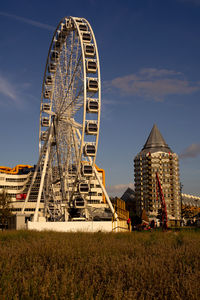 Low angle view of ferris wheel against sky