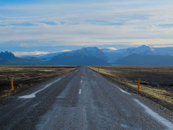 Empty road along countryside landscape