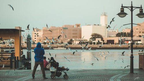 Man and dog against clear sky in city