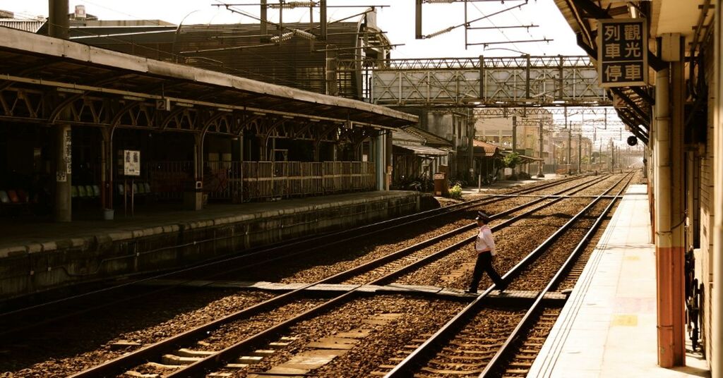 railroad track, rail transportation, railroad station platform, public transportation, railroad station, transportation, built structure, architecture, building exterior, train - vehicle, railway track, city, train, travel, passenger train, railway station, public transport, the way forward, diminishing perspective, sky