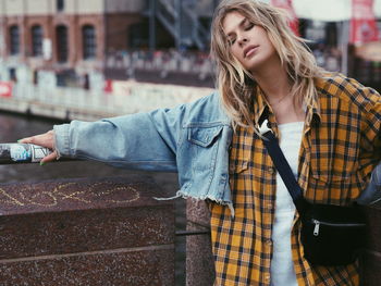 Portrait of woman standing in city