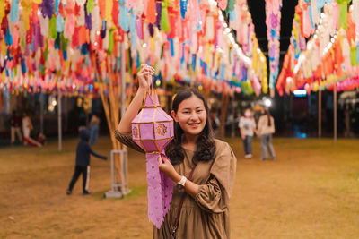 Portrait of a smiling young woman standing outdoors