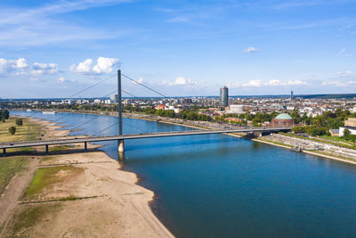 View of bridge over river against cloudy sky