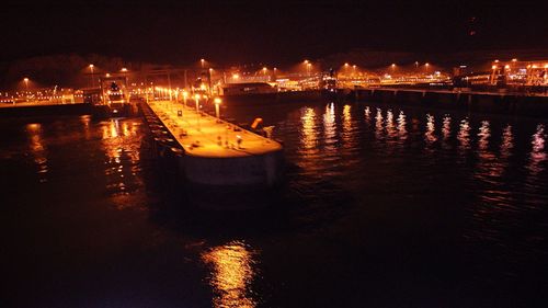 Boats in river at night