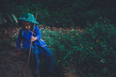 Young man looking away in forest