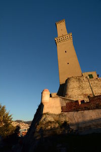 Low angle view of castle against clear blue sky