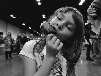 Girl eating frozen sweet food in city