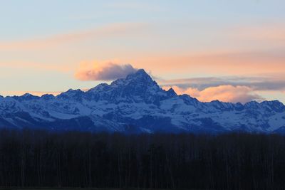 Scenic view of snowcapped mountains against sky during sunset