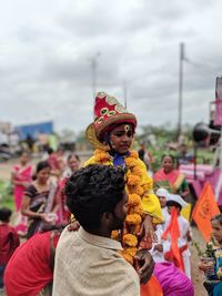 Rear view of people with toys against sky