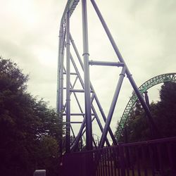 Low angle view of bridge against cloudy sky