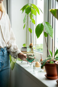 Midsection of woman holding potted plant