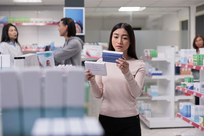 Portrait of young woman standing in laboratory